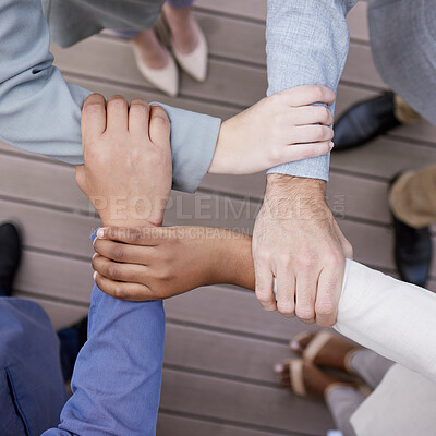Buy stock photo Cropped shot of a group of unrecognizable businesspeople linking arms