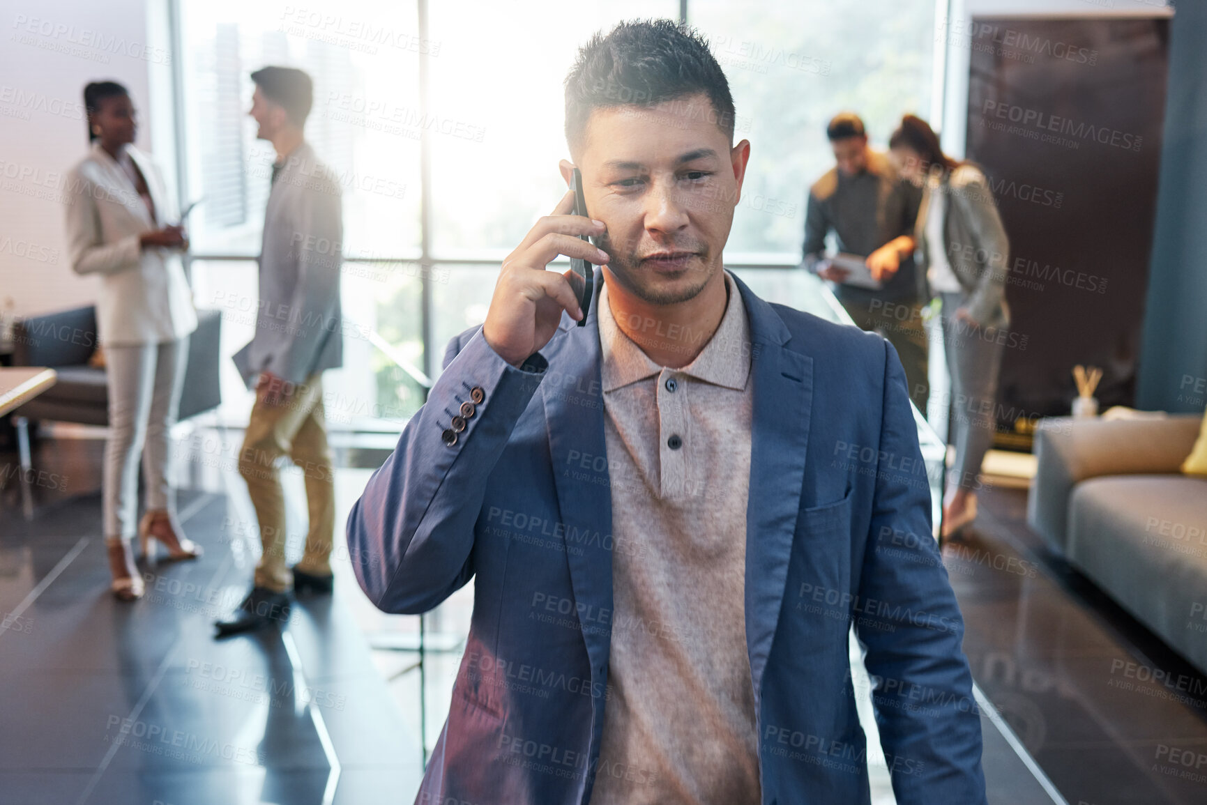 Buy stock photo Shot of a young businessman on a call at work