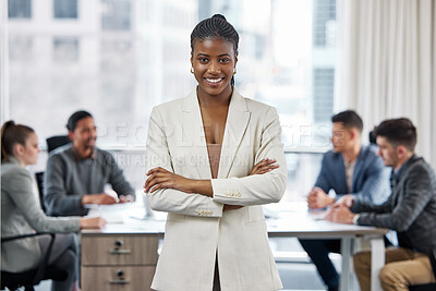 Buy stock photo Shot of a young businesswoman standing with her arms crossed in a meeting at work