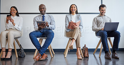 Buy stock photo Shot of a group of businesspeople using different forms of technology while waiting in line at an office