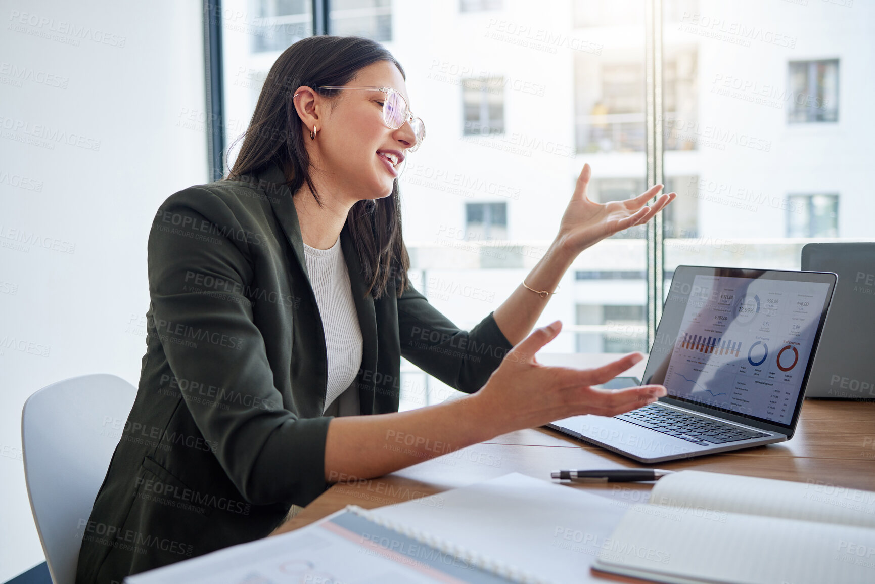 Buy stock photo Shot of a young businesswoman using a laptop in an office at work