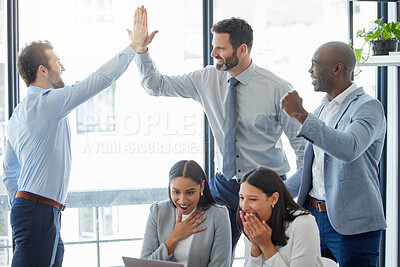 Buy stock photo Shot of a group of businesspeople celebrating while using a laptop in an office at work