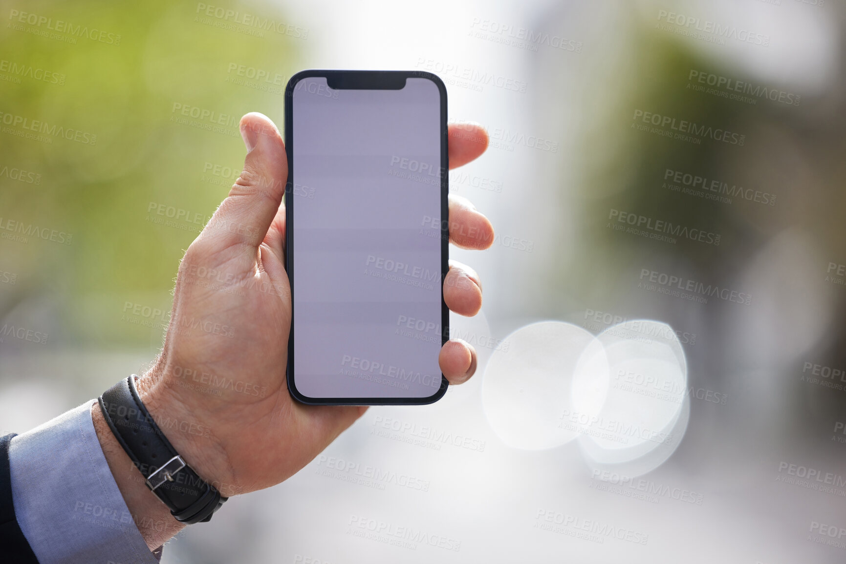 Buy stock photo Cropped shot of an unrecognizable businessman using his cellphone outside