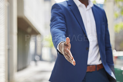 Buy stock photo Cropped shot of an unrecognizable businessman holding his hand out for a handshake in a modern office