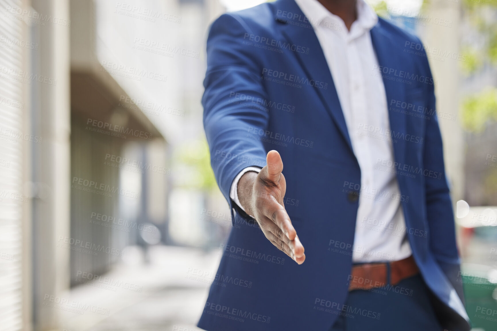 Buy stock photo Cropped shot of an unrecognizable businessman holding his hand out for a handshake in a modern office