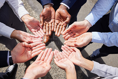 Buy stock photo Shot of a group of unrecognizable businesspeople joining their hands together outside