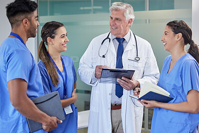 Buy stock photo Shot of a group of doctors having a meeting at a hospital