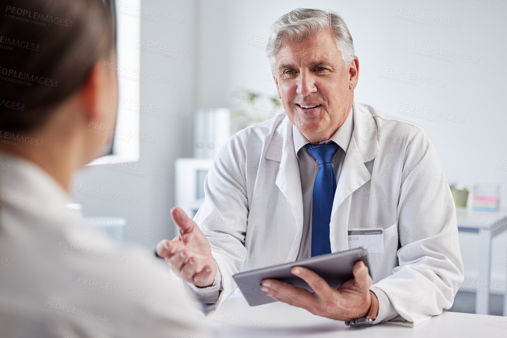 Buy stock photo Mature doctor, man and consultation with patient, tablet or happy for giving advice, results or good news. Medic, people and digital touchscreen for report, diagnosis and healthcare service in clinic