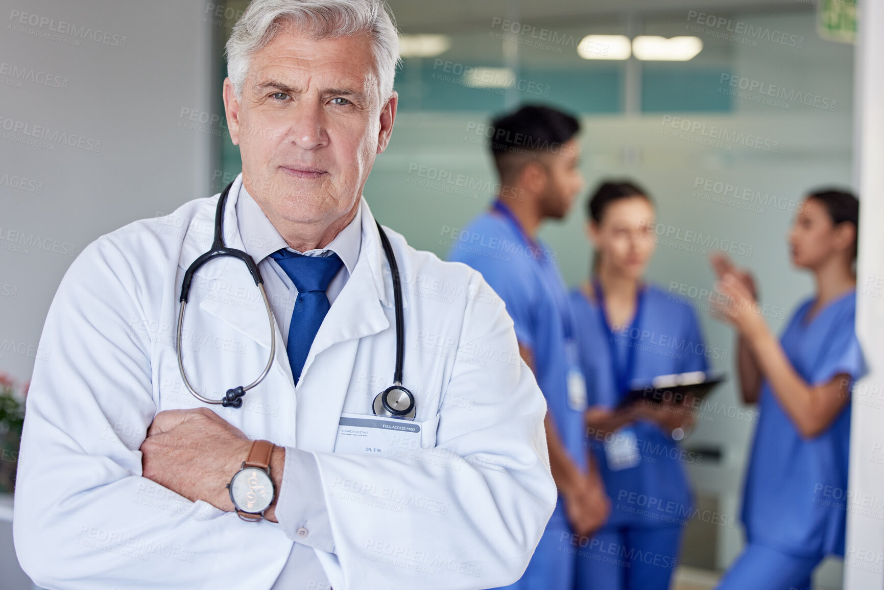 Buy stock photo Mature doctor, man and arms crossed in portrait at hospital with confidence, team and healthcare services. Senior medic, expert or specialist with pride for professional career with staff in clinic