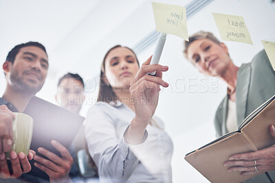 Buy stock photo Teamwork, writing and business people on glass board for planning, brainstorming and schedule or workflow notes. Notebook, tablet and women, men or group with sticky note ideas, solution and window 
