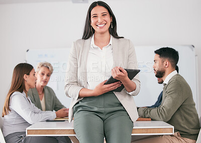 Buy stock photo Shot of a young businesswoman using her digital tablet during a meeting