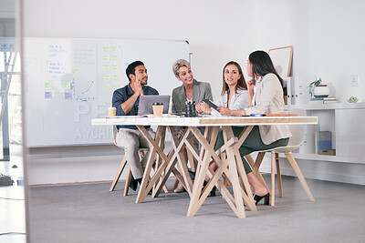 Buy stock photo Shot of a team of business people brainstorming in their office