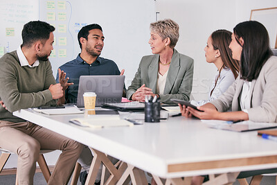 Buy stock photo Shot of a team of business people brainstorming in their office
