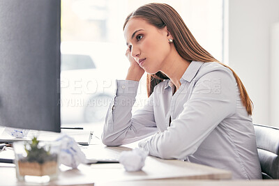 Buy stock photo Shot of an attractive young businesswoman sitting alone in the office and feeling bored while using her computer