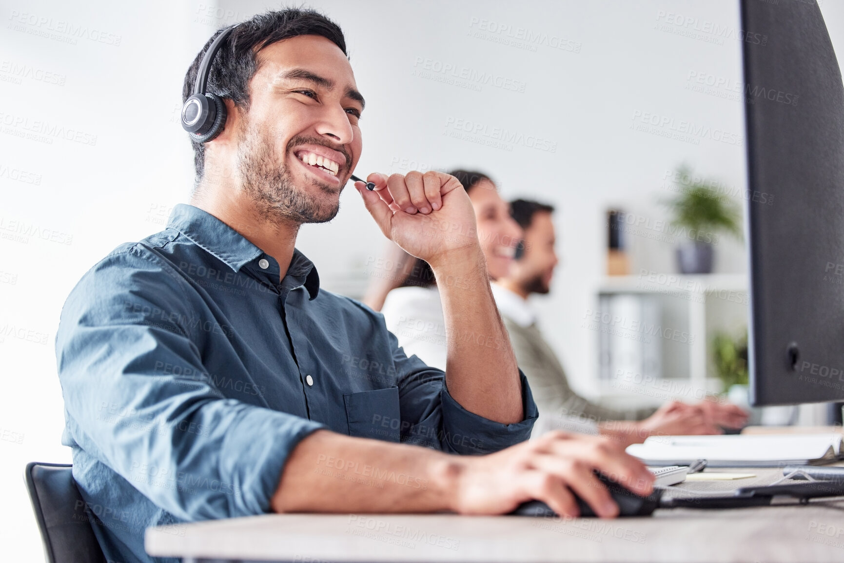 Buy stock photo Cropped shot of a handsome young male call center agent working in his office