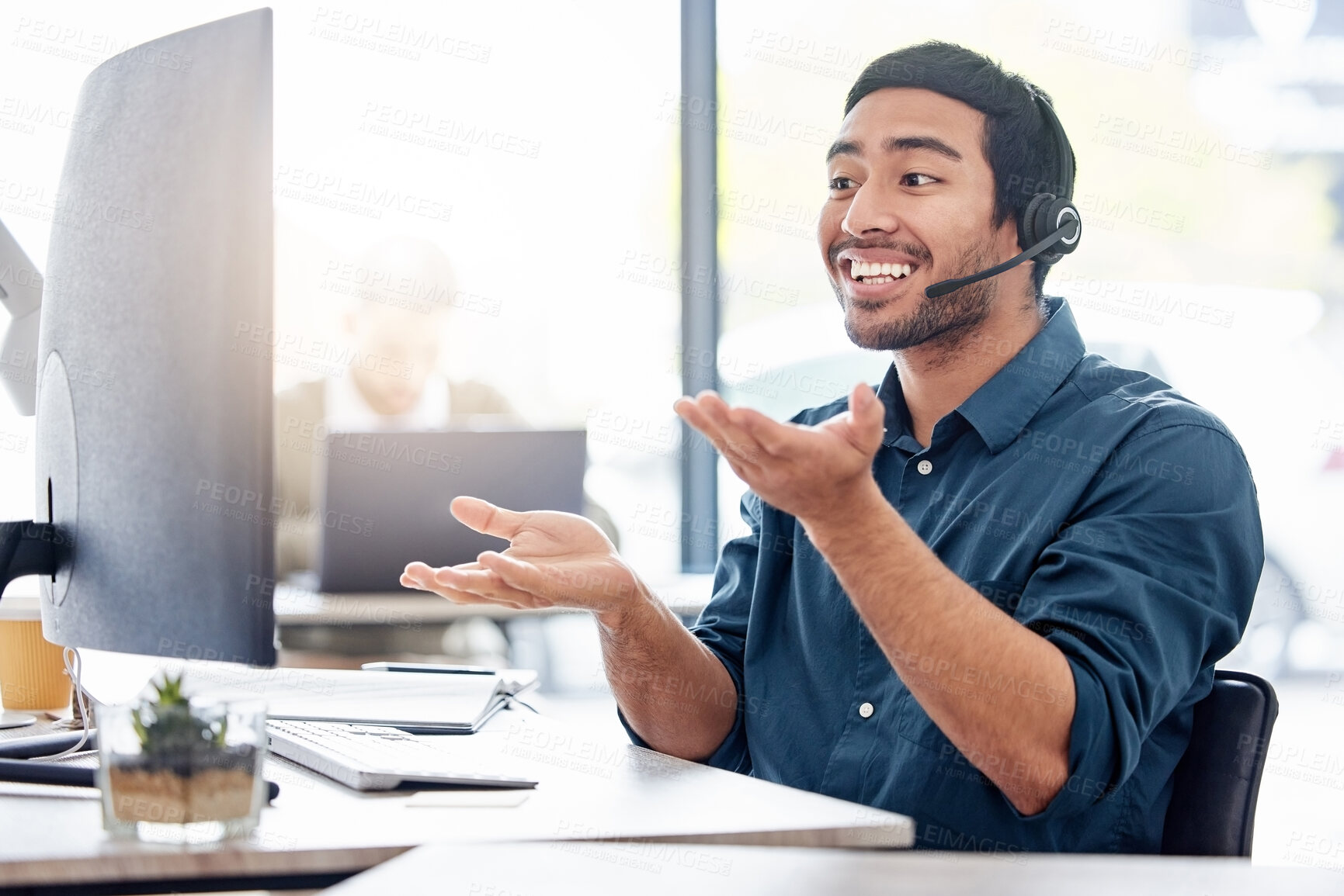 Buy stock photo Cropped shot of a handsome young male call center agent working in his office