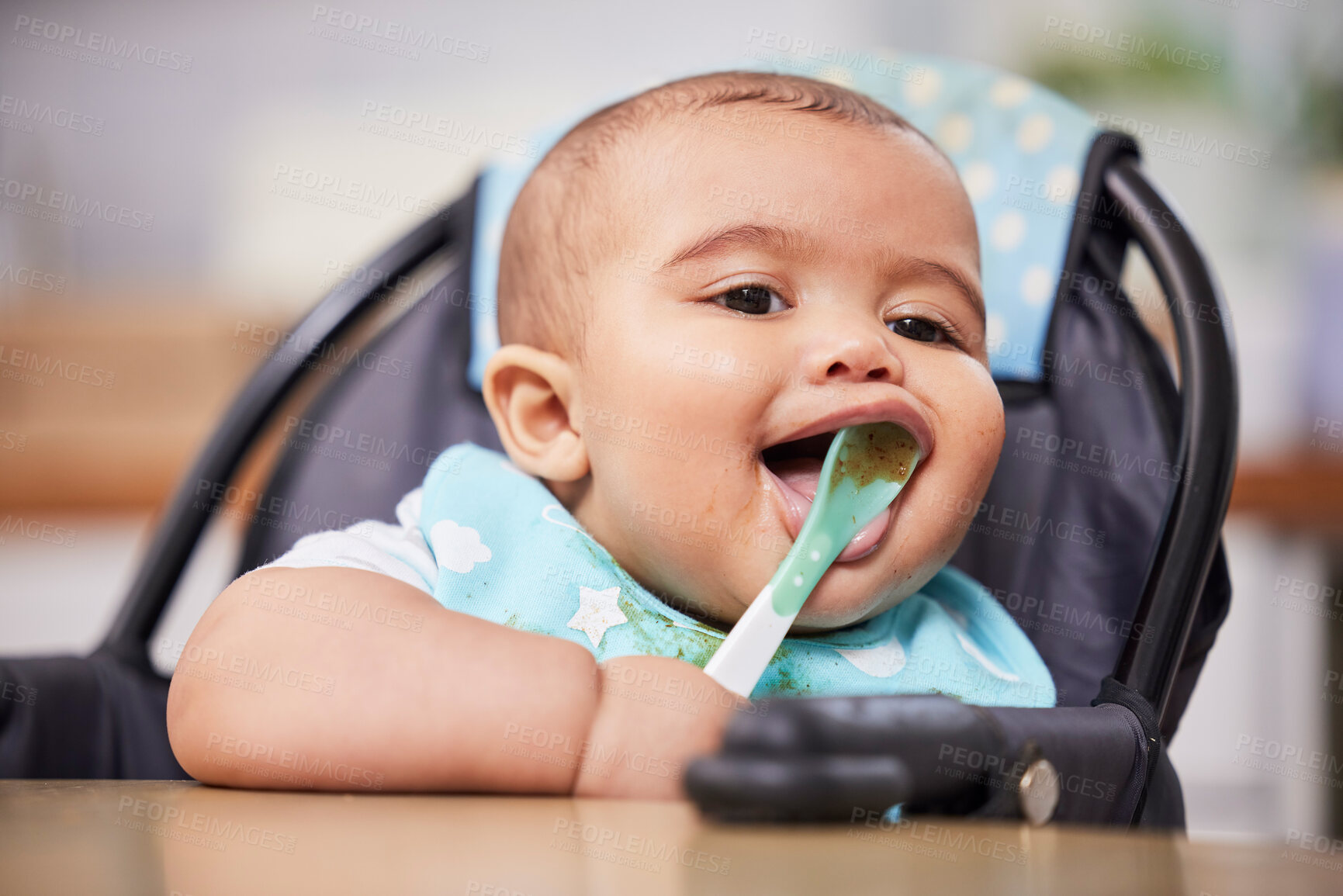 Buy stock photo Happy, healthy and face of baby with spoon, food and smile in growth, child development and breakfast in high chair. Diet, nutrition and hungry infant at table for fun morning eating schedule in home