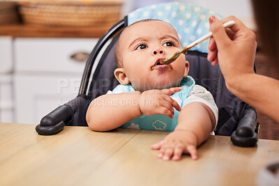 Buy stock photo Shot of a mother feeding her adorable baby boy