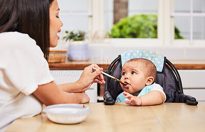 Buy stock photo Shot of a mother feeding her adorable baby boy