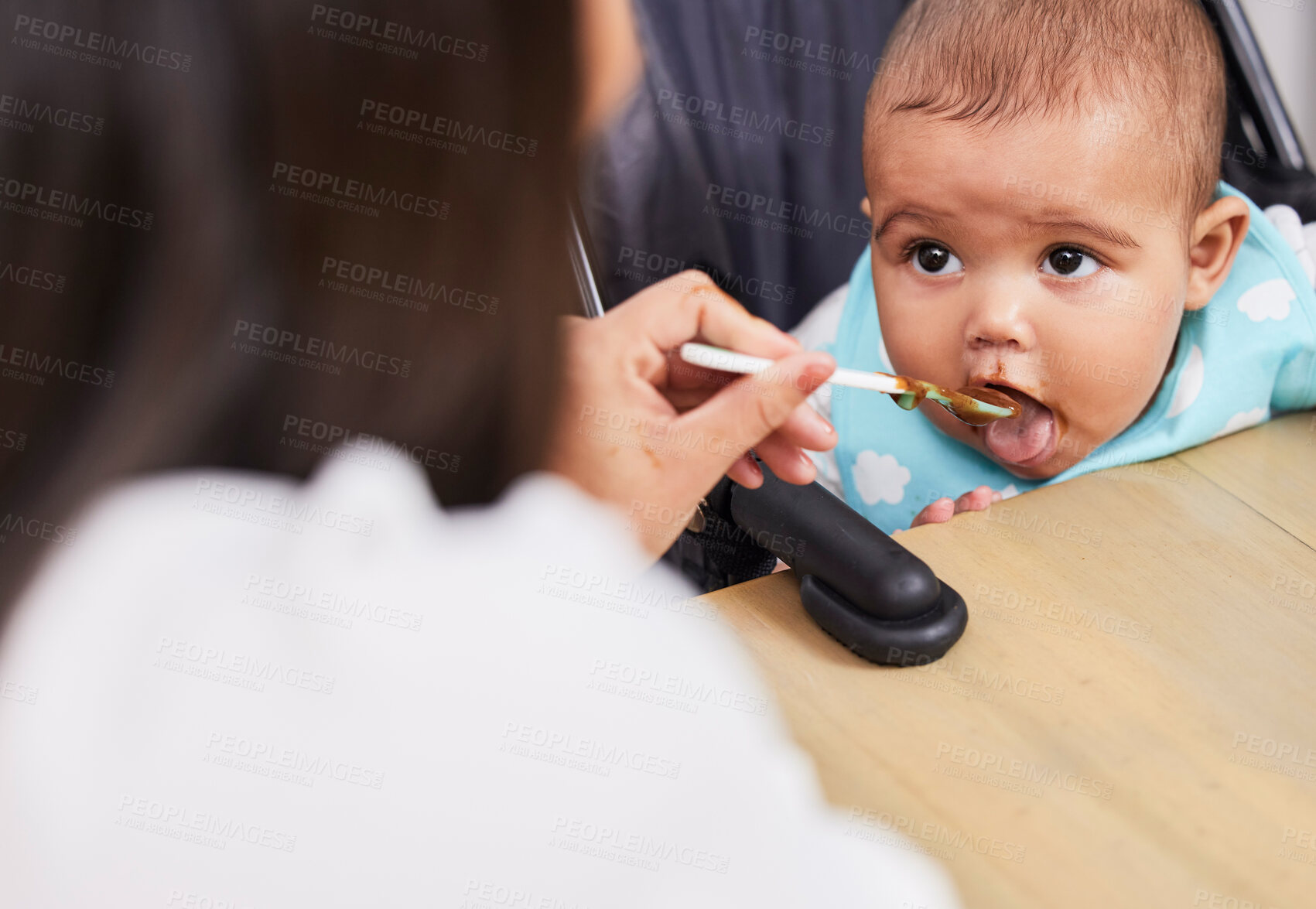 Buy stock photo Shot of a mother feeding her adorable baby boy