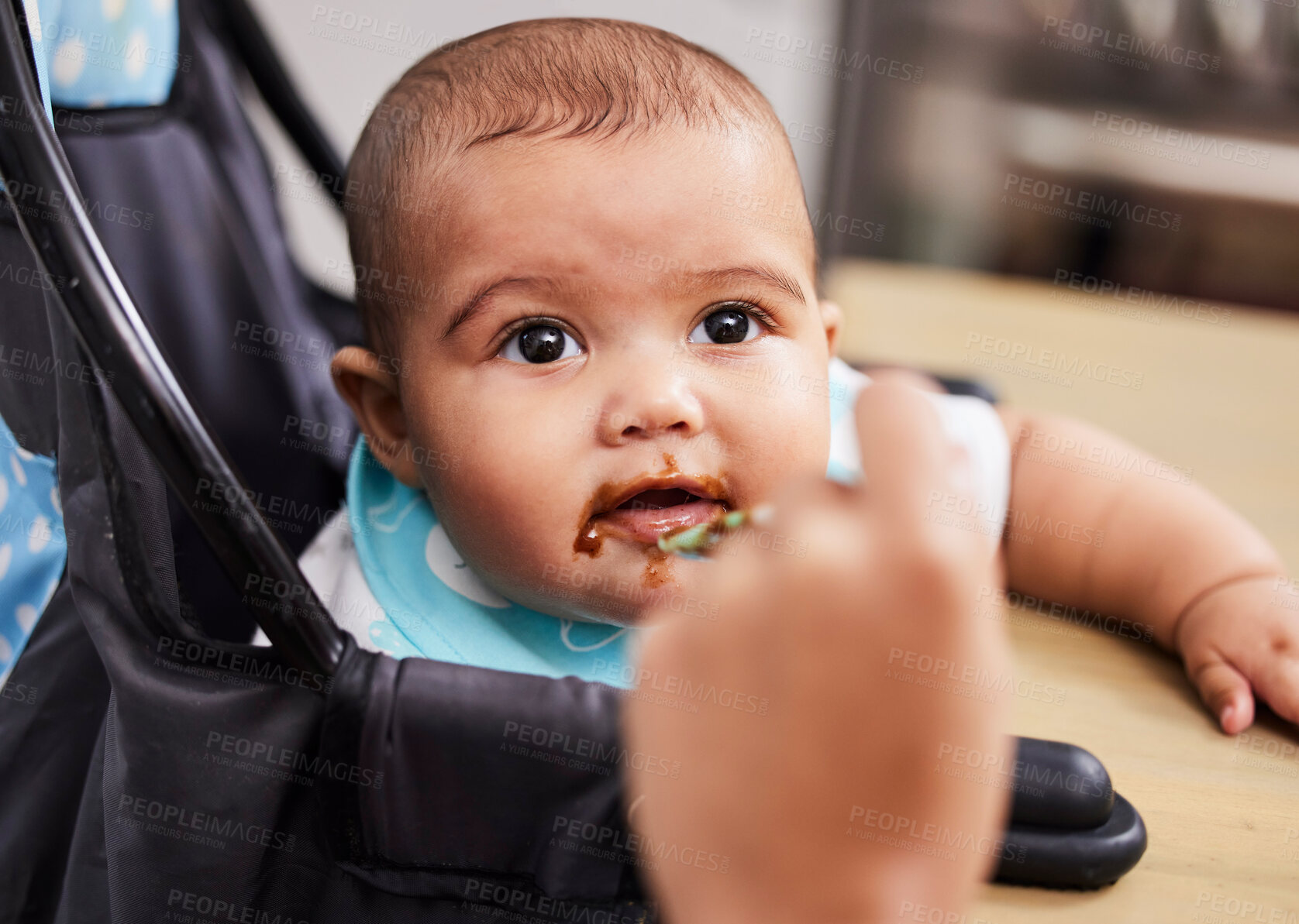 Buy stock photo Shot of a mother feeding her adorable baby boy