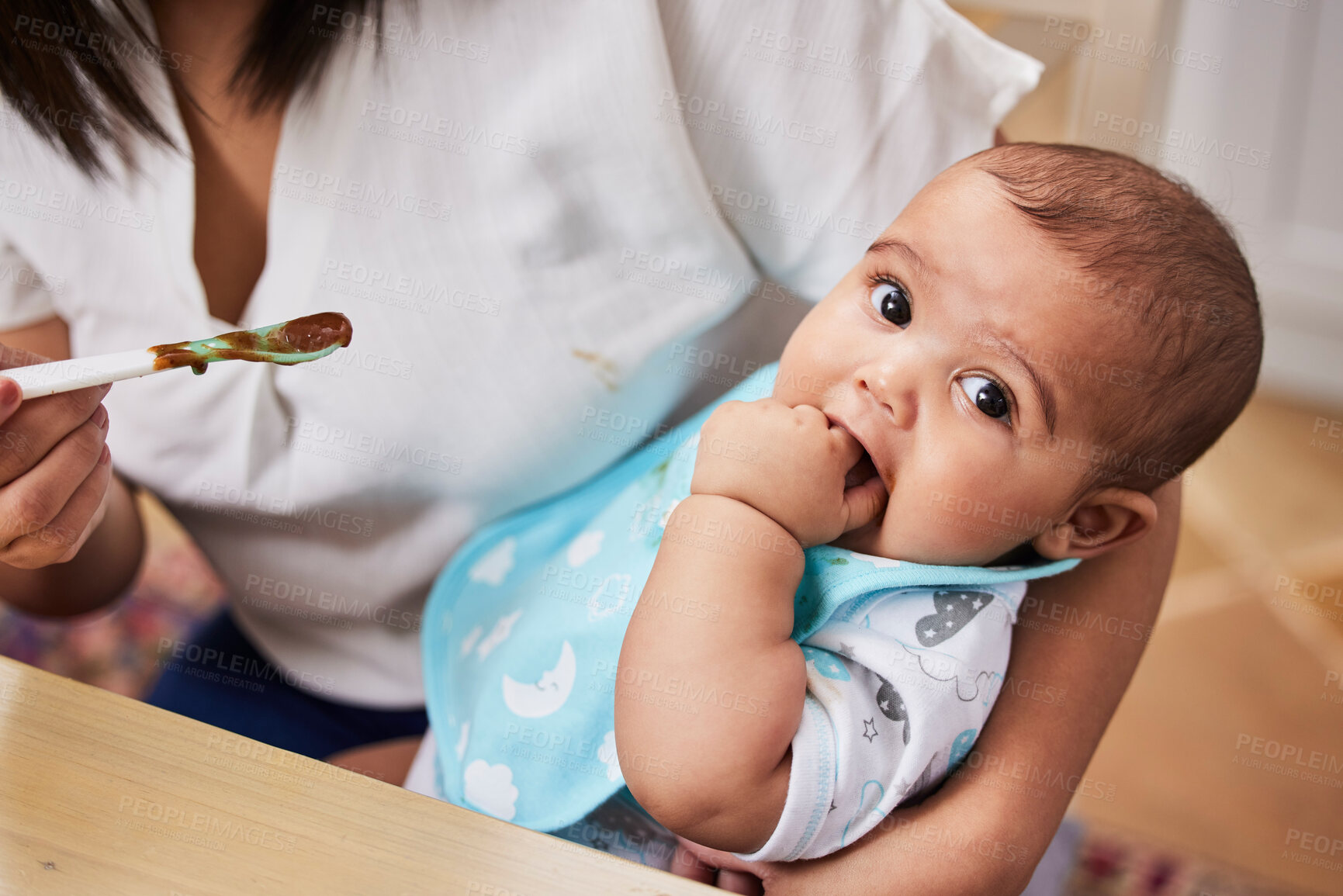 Buy stock photo Shot of a mother feeding her adorable baby boy