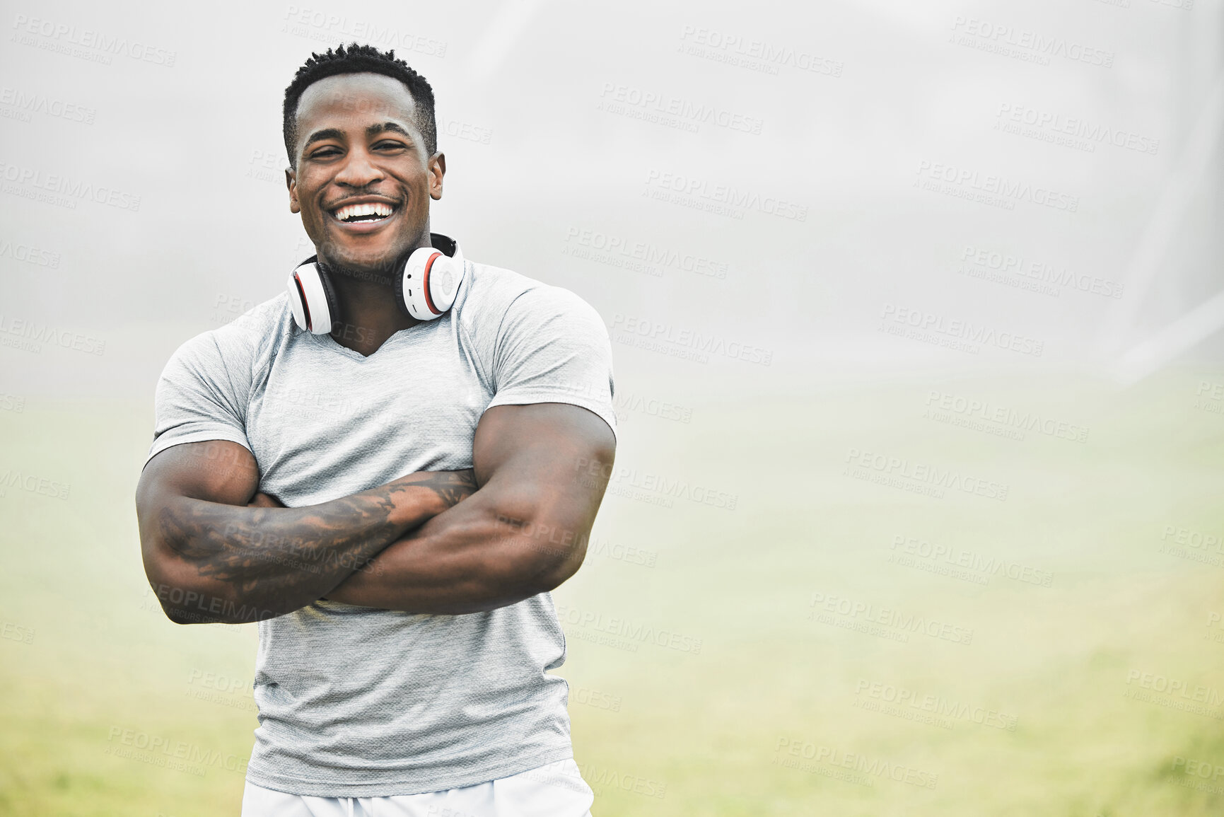 Buy stock photo Black man, portrait and confidence outdoor for fitness, wellness and health goals achievement in morning. Athlete, face and crossed arms on field for workout, training and exercise with headphones