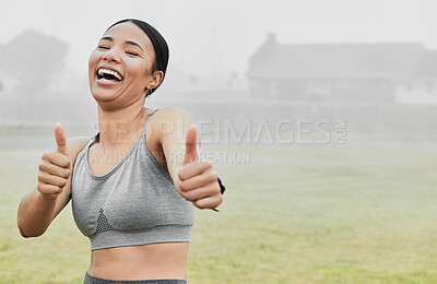 Buy stock photo Cropped portrait of an attractive young female athlete giving thumbs up towards the camera while exercising outside