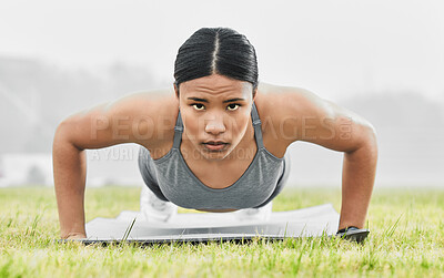 Buy stock photo Full length portrait of an attractive young female athlete doing pushups while exercising outside
