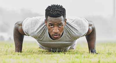 Buy stock photo Full length portrait of a handsome young male athlete doing pushups while exercising outside