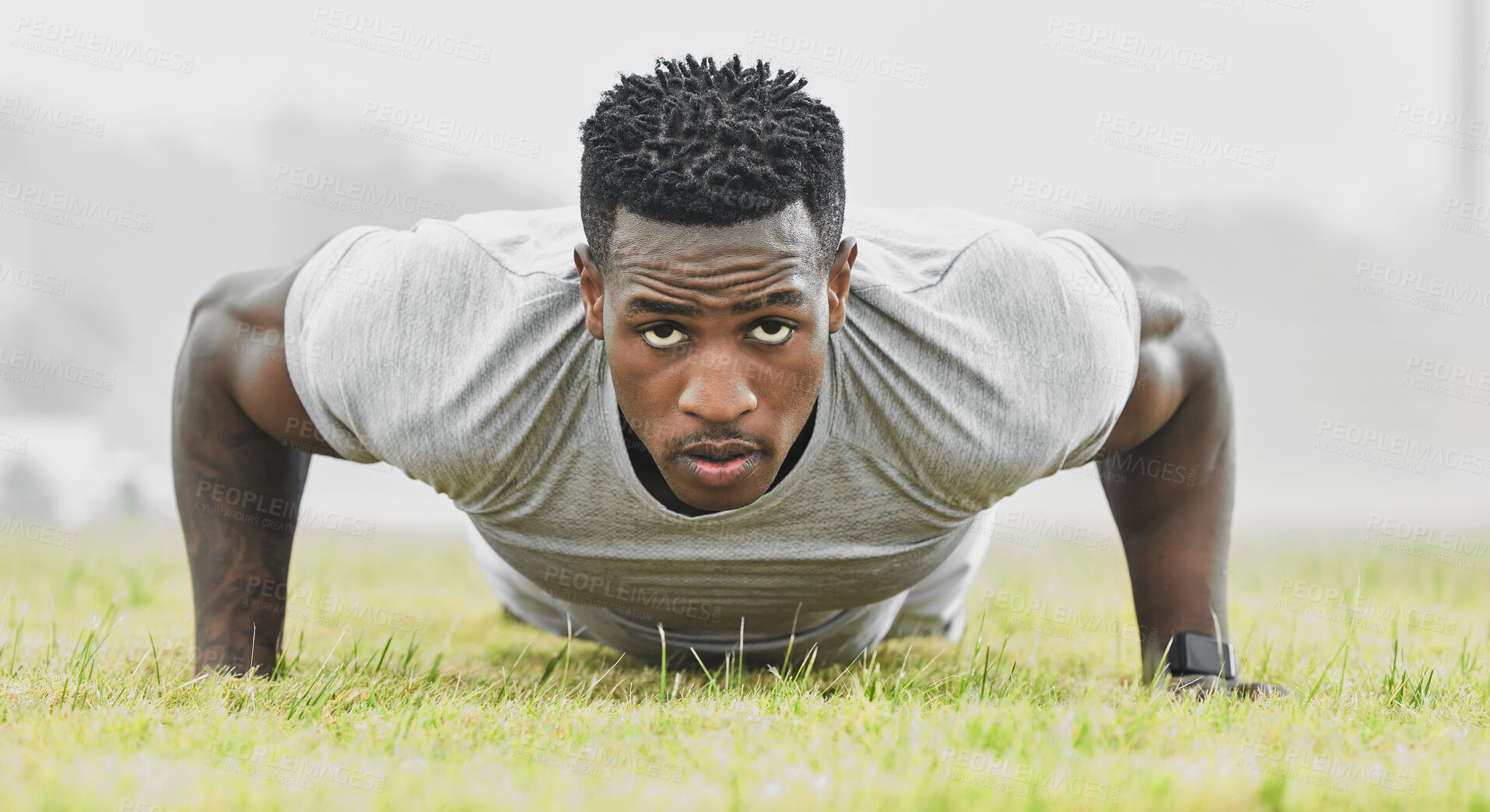 Buy stock photo Full length portrait of a handsome young male athlete doing pushups while exercising outside