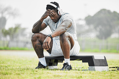 Buy stock photo Full length shot of a handsome young male athlete taking a break while exercising outside