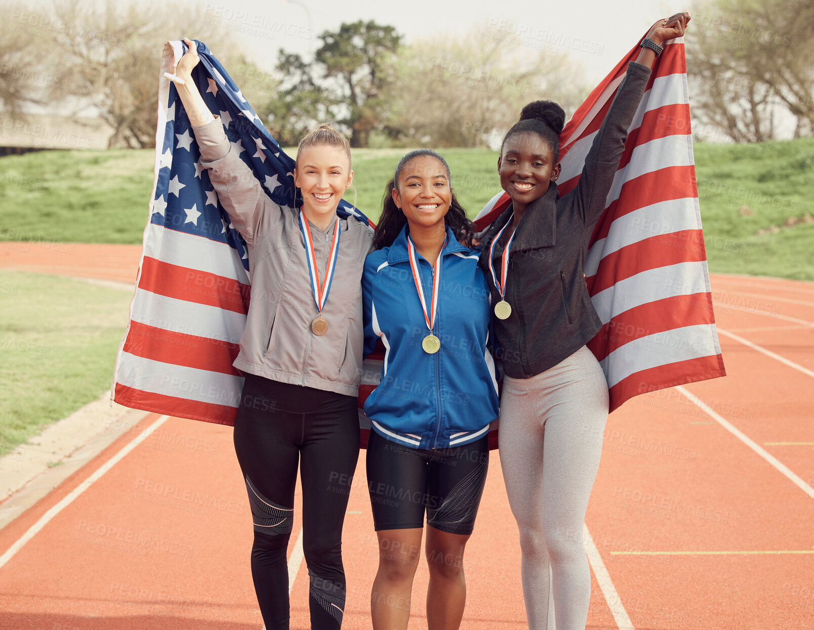 Buy stock photo Winning flag, athlete and portrait of woman team on race track for celebration, achievement and happy for medal. American group, people and smile for success, event victory or relay champion on field