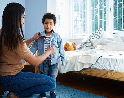 Buy stock photo Mother, boy and dressing with clothes in bedroom, home and love for care with helping hand in morning. Woman, mom and child with style, teaching or prepare for kindergarten in family house in Bogota