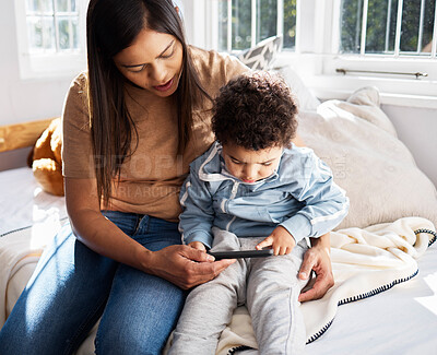 Buy stock photo Home, woman and toddler with phone on bed for online education games, website and child development. Family, mother and son with techology in house for digital learning, knowledge and entertainment