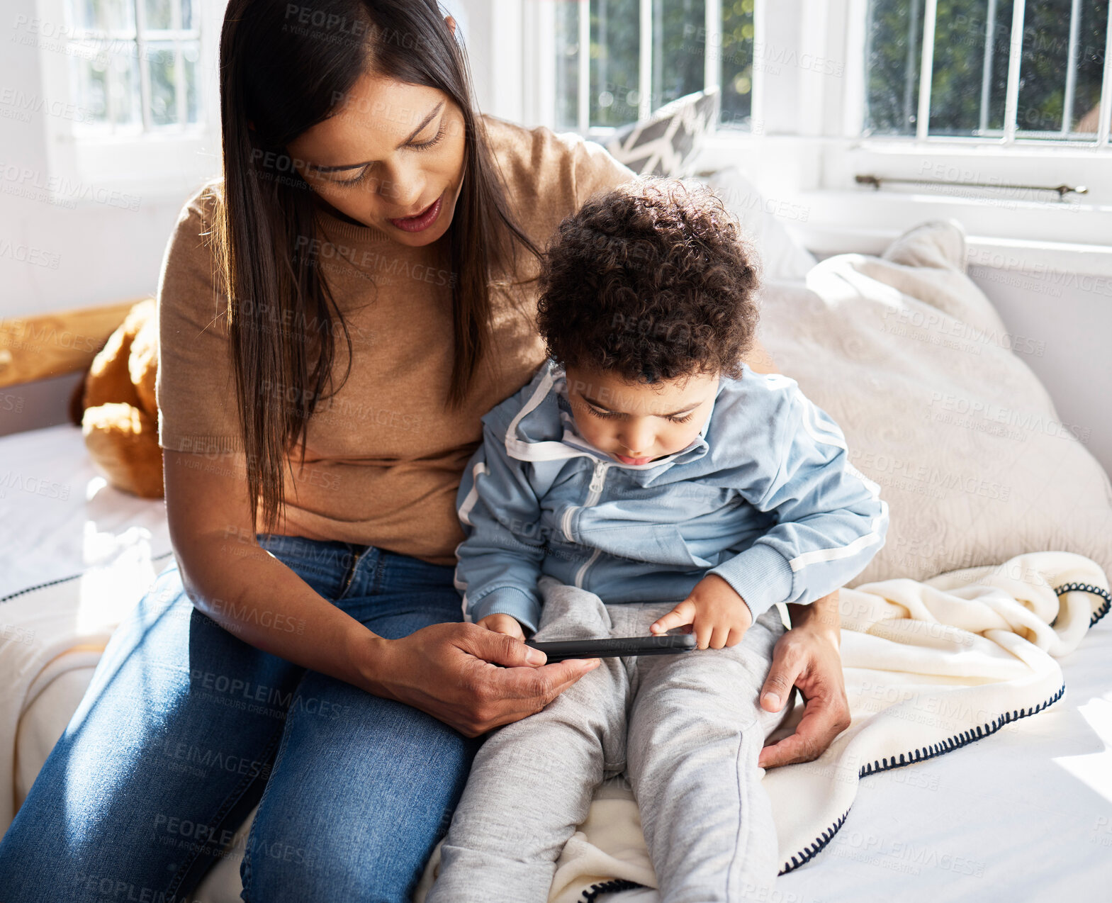 Buy stock photo Home, woman and toddler with phone on bed for online education games, website and child development. Family, mother and son with techology in house for digital learning, knowledge and entertainment