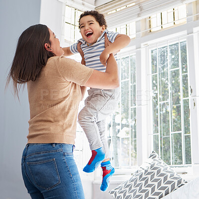 Buy stock photo Playful, smile and woman with lifting of kid at home for love, support and bonding together. Family, mother and son with fun game in living room for weekend, happiness and childhood development