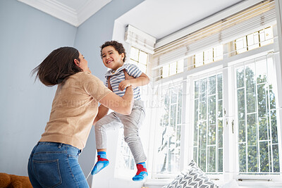 Buy stock photo Mother, child and jump in bedroom for fun, playful and connection for bonding together in home. Happy people, mom and boy with lifting for game, entertainment and energy of single parent with kid 