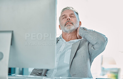 Buy stock photo Shot of a mature businessman suffering with neck pain while working in an office
