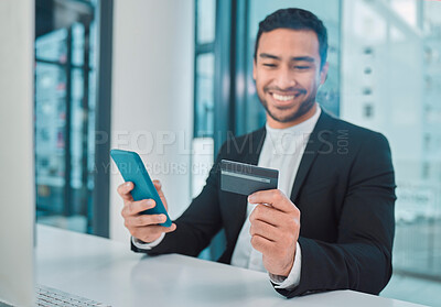 Buy stock photo Shot of a businessman using a phone and credit card at work