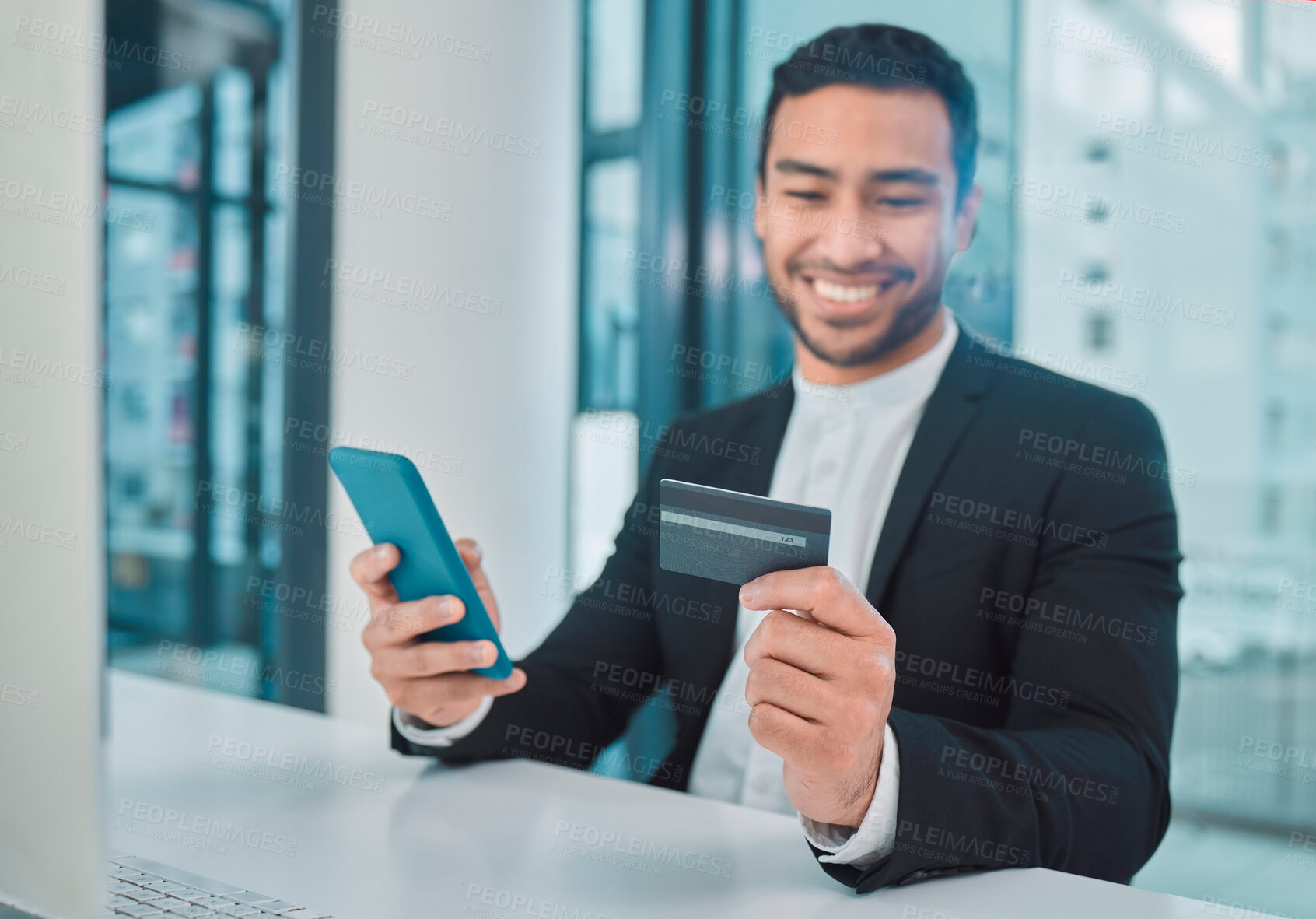 Buy stock photo Shot of a businessman using a phone and credit card at work