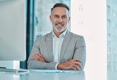 Buy stock photo Shot of a mature businessman sitting at a desk at work