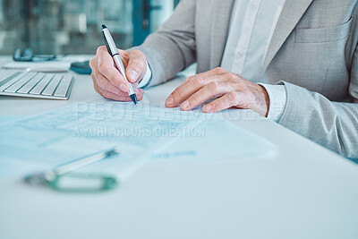Buy stock photo Shot of an unrecognisable businessman filling in a form on a desk in an office