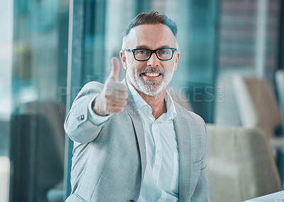 Buy stock photo Shot of a mature businessman showing a thumbs up at work