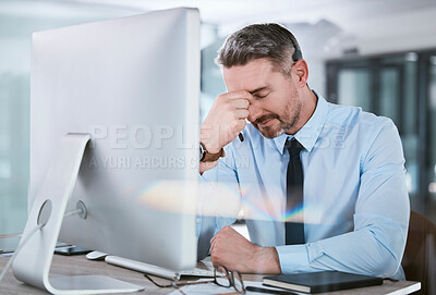 Buy stock photo Shot of a mature call centre agent looking stressed out while working on a computer in an office