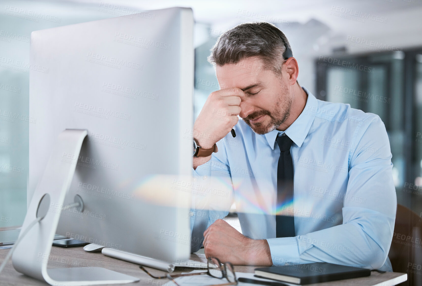 Buy stock photo Call center, stress and businessman with headache at desk for telecom mistake, consulting or fatigue. Office, mature agent and frustrated in pain by monitor for customer support, complaint or burnout