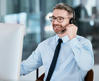 Buy stock photo Shot of a mature call centre agent working on a computer in an office