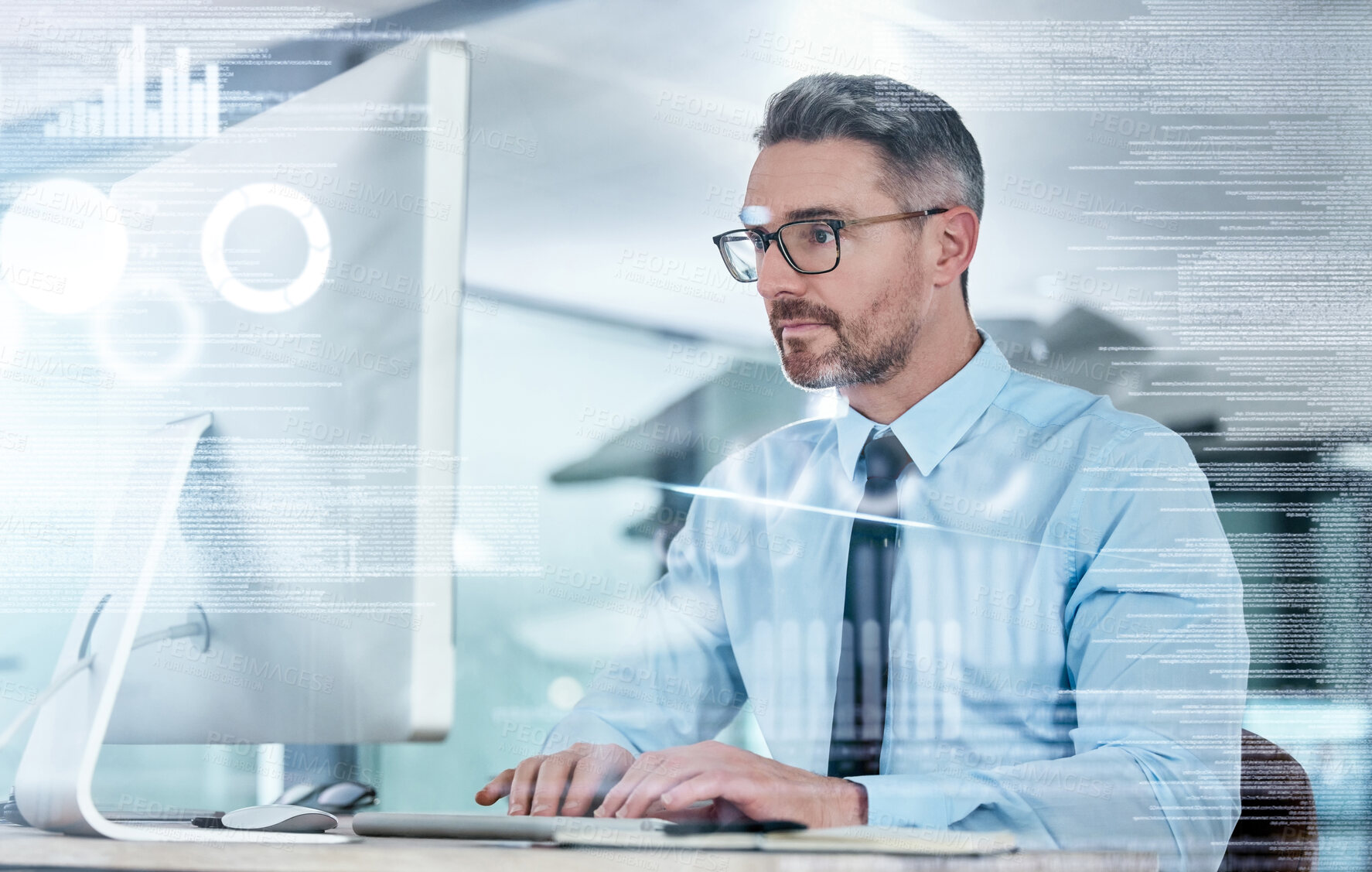 Buy stock photo Shot of a mature businessman working on a computer in an office