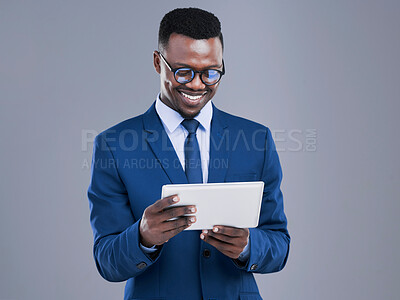 Buy stock photo Black man, tablet and business analyst in a studio with technology reading online on a app. Gray background, professional and African male person with tech streaming a social media video with a smile