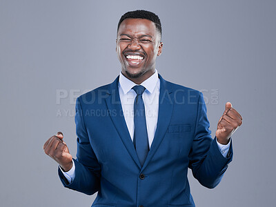 Buy stock photo Cropped shot of a handsome young businessman cheering in studio against a grey background